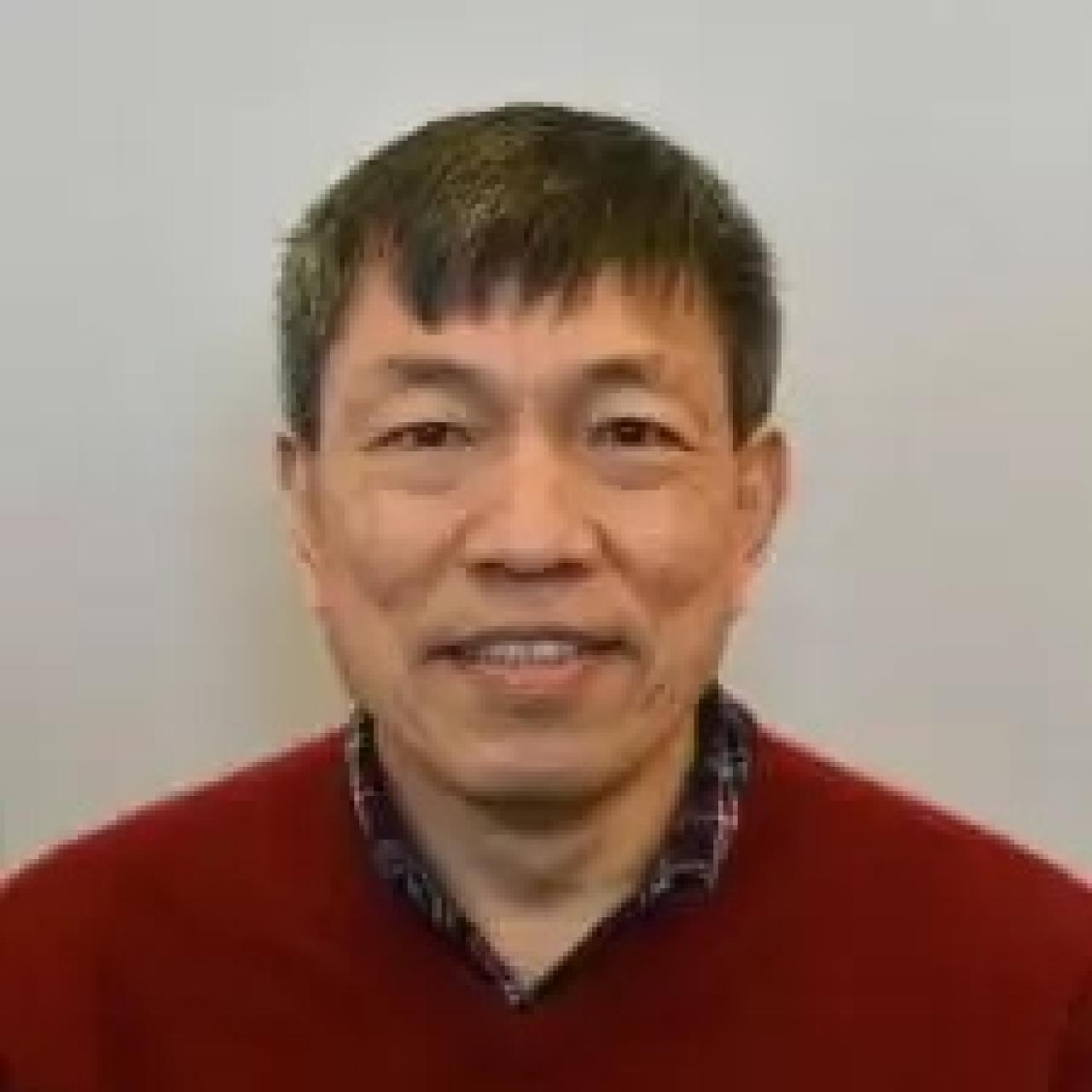 Peter Ling smiling and wearing a red shirt