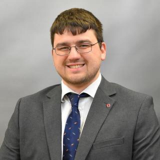 john trzinski smiling and wearing a suit