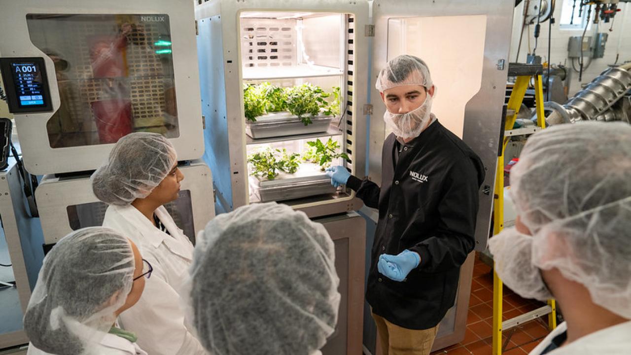 Simunauts receiving instruction from scientist
